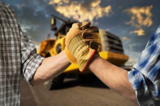 Builder or engineer handshake on the construction background